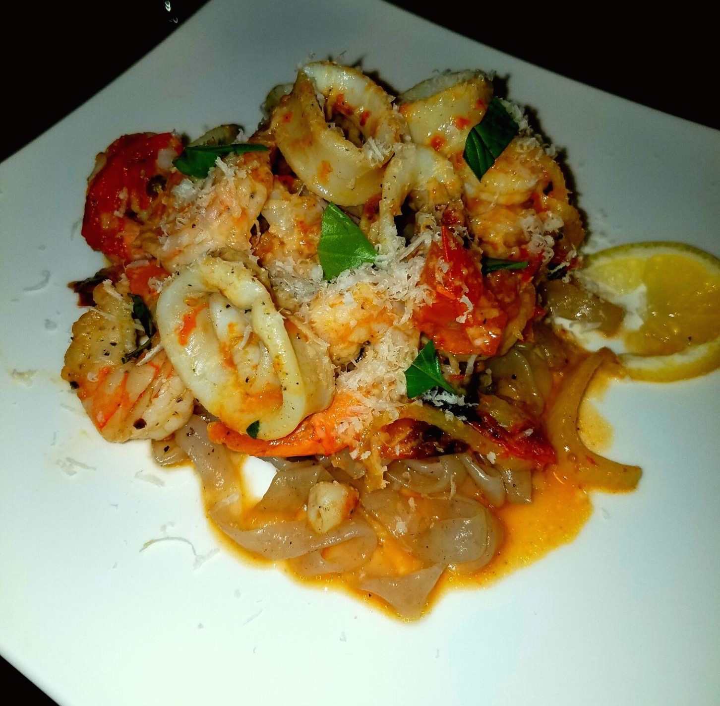 Calamari and shrimp in roasted baby heirloom caper fennel white wine sauce